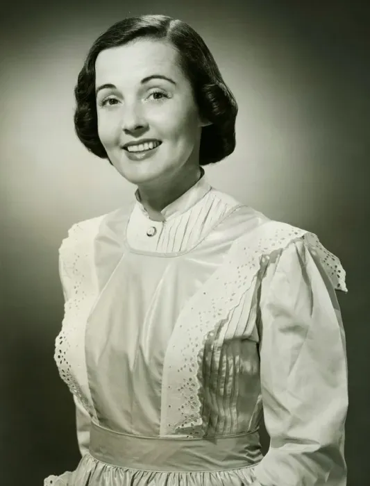 Framed Print : Woman in white apron posing in studio, (B&W), (Portrait) Framed Print : Woman in white apron posing in studio, (B&W), (Portrait)