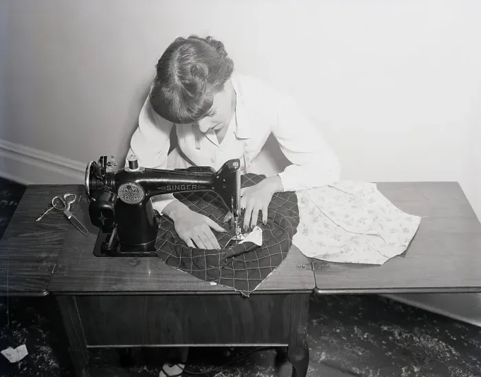 Framed Print : Woman Working On Sewing Machine Framed Print : Woman Working On Sewing Machine