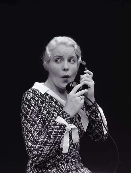 Woman with worried expression, on telephone. (Photo by H