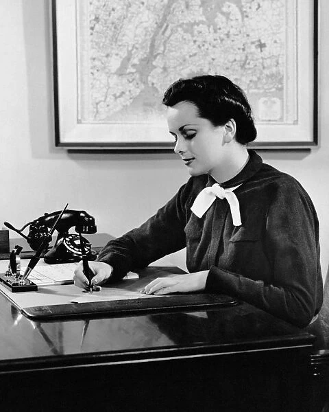 Woman writing at desk