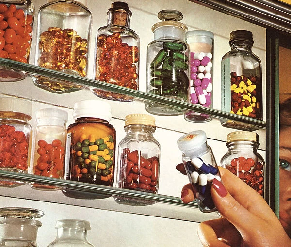 Womans Hand in Medicine Cabinet