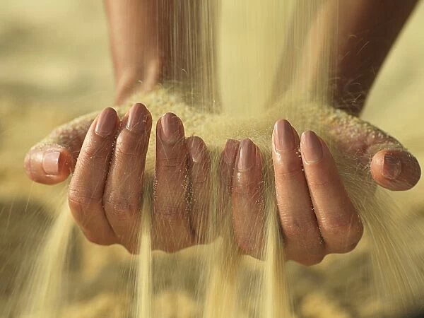 Woman's hands holding sand