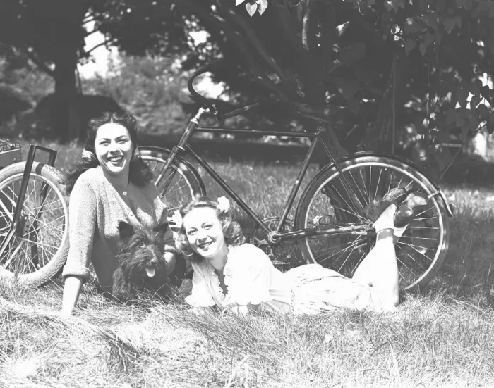Framed Print : Two women and dog resting on grass, (B&W) Framed Print : Two women and dog resting on grass, (B&W)