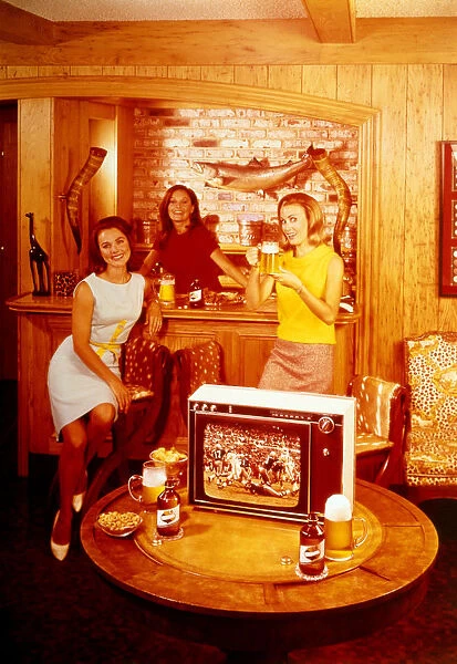 WOMEN DRINKING BEER AND WATCHING FOOTBALL