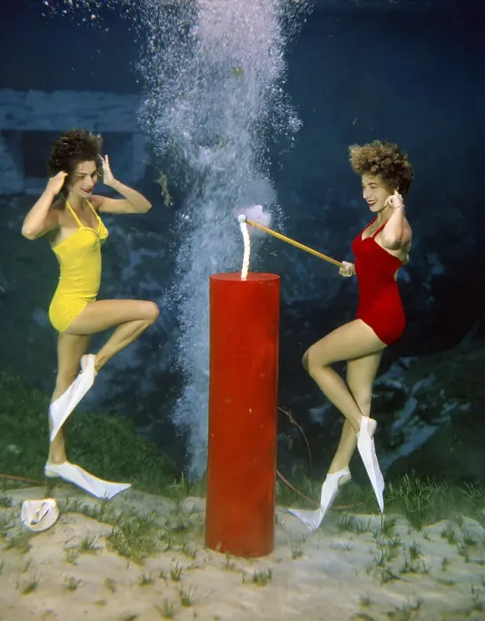 Framed Print : Women Lighting a Firecracker Underwater Framed Print : Women Lighting a Firecracker Underwater