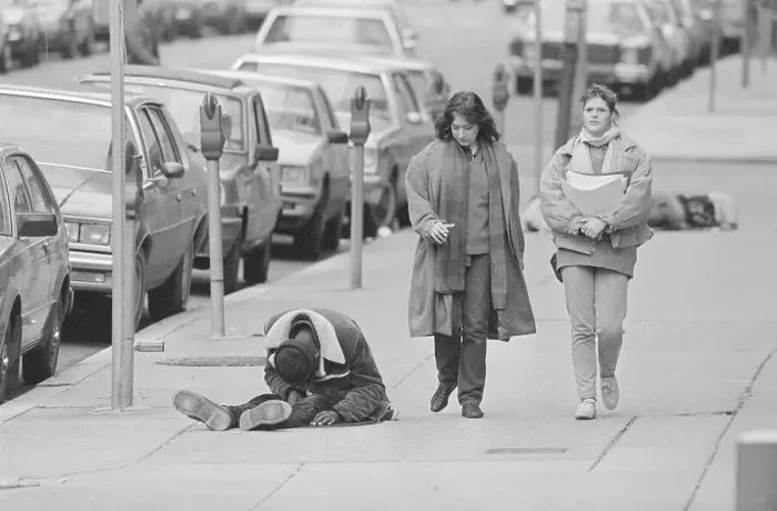 Framed Print : Two Women Passing by a Homeless Man Framed Print : Two Women Passing by a Homeless Man