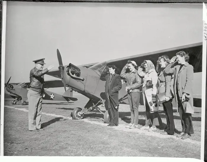 Framed Print : Women Pilots Saluting Near Airplane Framed Print : Women Pilots Saluting Near Airplane