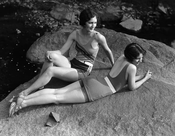 Two women relaxing on rock, by creek. (Photo by H. Armstrong Roberts  /  Retrofile  /  Getty Images)