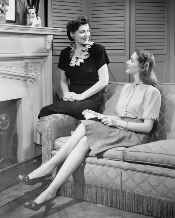 Framed Print : Two women sitting on couch, discussing, (B&W) Framed Print : Two women sitting on couch, discussing, (B&W)