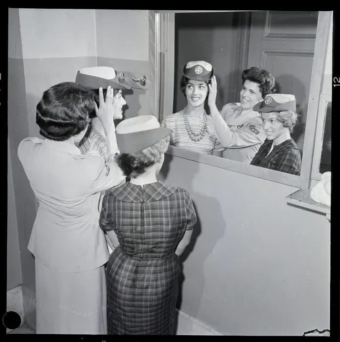 Framed Print : Women Try On Military Hats In Mirror Framed Print : Women Try On Military Hats In Mirror