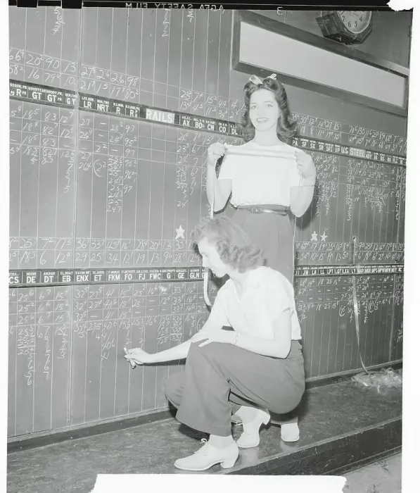 Framed Print : Women Updating a Stock Board Framed Print : Women Updating a Stock Board