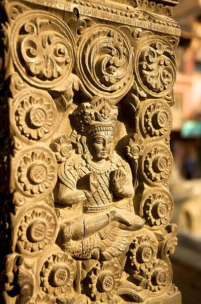 Woodcarving with god Shiva on the buttress of a house, Bhaktapur, Nepal, Asia
