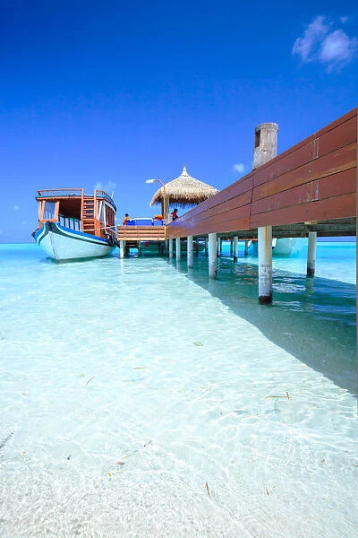 Wooden pier with boat, side view, Maldives