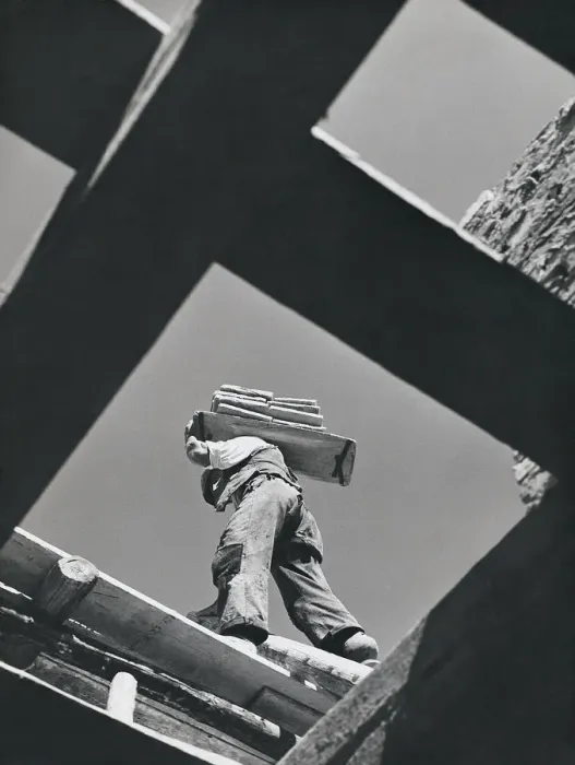 Framed Print : Worker carrying materials, seen from below Framed Print : Worker carrying materials, seen from below