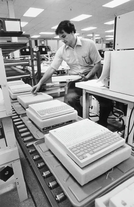 Framed Print : Worker Examines Apple IIc Computer Framed Print : Worker Examines Apple IIc Computer