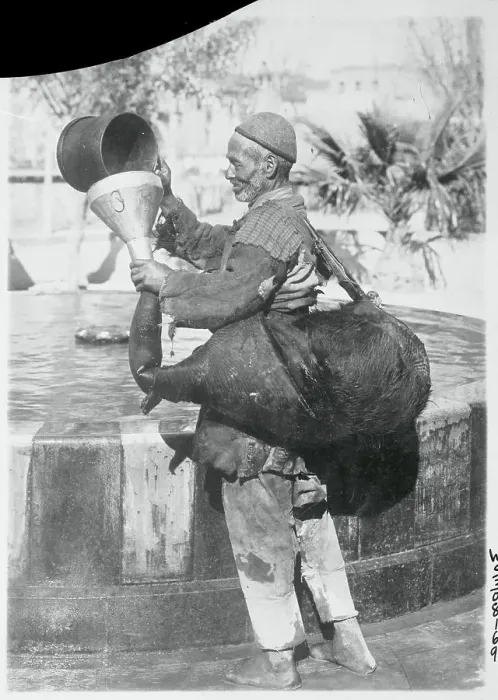 Framed Print : Worker Filling Pigskin with Water