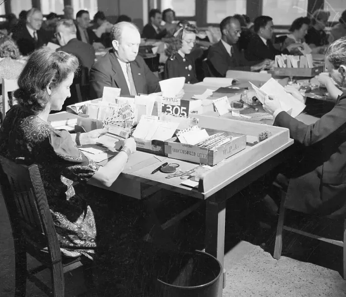 Framed Print : Worker In Post Office Inspects Envelopes