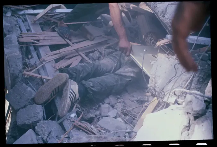 Framed Print : Worker Uncovering Victim of Bomb Blast