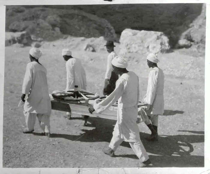 Framed Print : Workers Carrying Chariot Wheels on Stretcher Framed Print : Workers Carrying Chariot Wheels on Stretcher