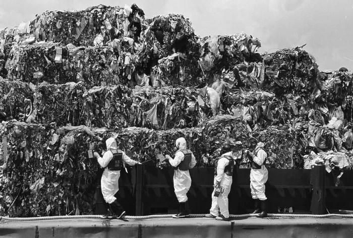 Framed Print : Workers Inspecting Garbage On Barge Framed Print : Workers Inspecting Garbage On Barge