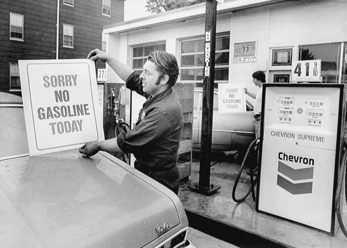 Framed Print : Workers Placing Signs on Gas Pumps Framed Print : Workers Placing Signs on Gas Pumps