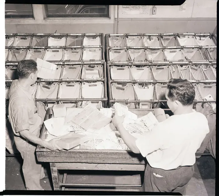 Framed Print : Workers Sort Letters into Airmail Bags Framed Print : Workers Sort Letters into Airmail Bags