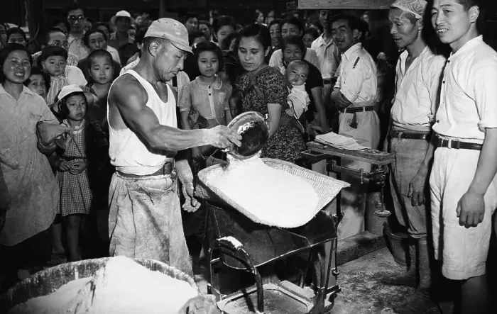 Framed Print : Workman Measures Food Ration For Woman Framed Print : Workman Measures Food Ration For Woman