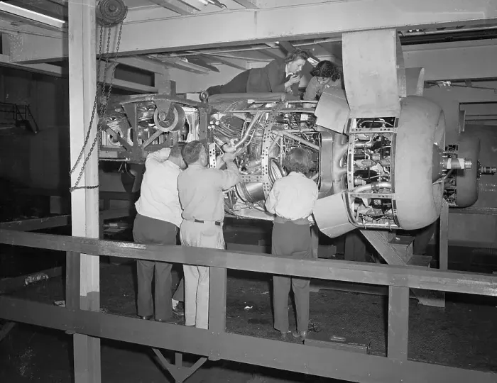 Framed Print : Workmen Fitting a Motor into a Bomber Plane Framed Print : Workmen Fitting a Motor into a Bomber Plane