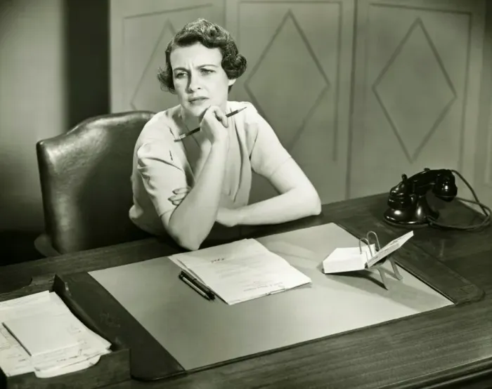Framed Print : Worrying woman sitting at desk in office, (B&W) Framed Print : Worrying woman sitting at desk in office, (B&W)