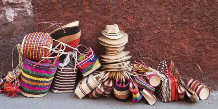 Framed Print : Woven souvenirs on display on a sidewalk against a wall Framed Print : Woven souvenirs on display on a sidewalk against a wall