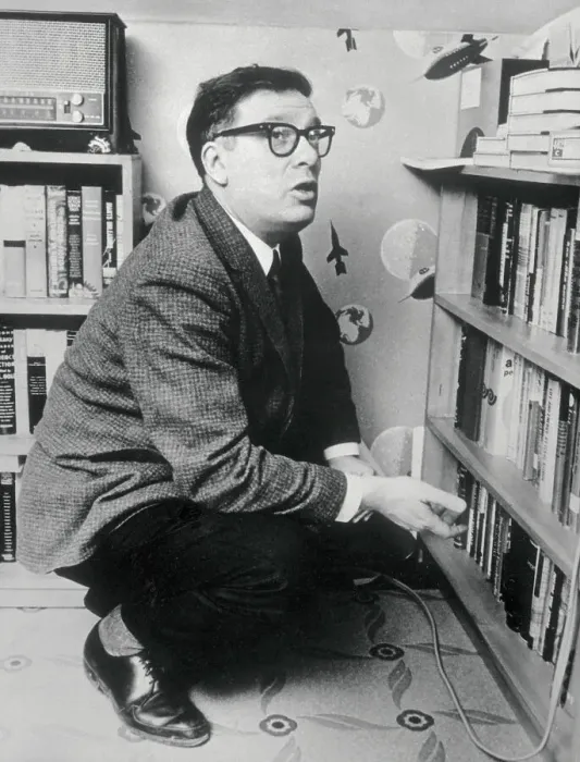 Framed Print : Writer Isaac Asimov Squatting by Bookcase Framed Print : Writer Isaac Asimov Squatting by Bookcase