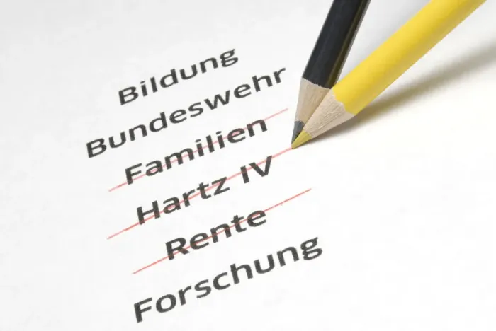 Framed Print : A yellow and a black pencil crossing out the letterings Familien, Hartz IV and Rente, German for families, Hartz IV, a German unemployment benefit, and pension, symbolic image for the policy of economy measures of the Conservative Parties in Germany Framed Print : A yellow and a black pencil crossing out the letterings Familien, Hartz IV and Rente, German for families, Hartz IV, a German unemployment benefit, and pension, symbolic image for the policy of economy measures of the Conservative Parties in Germany
