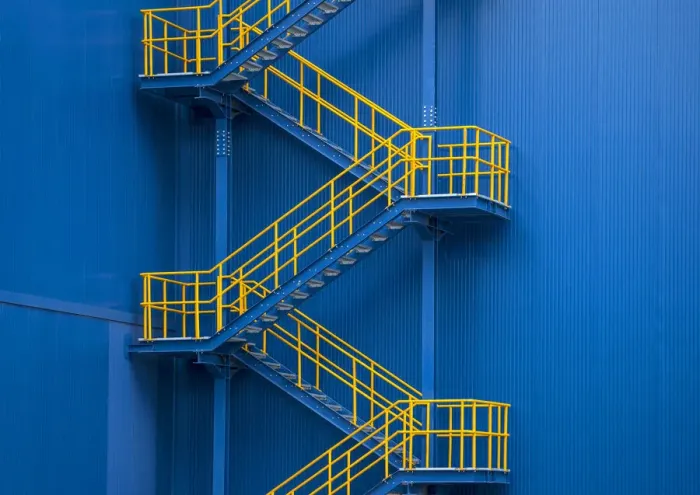 Framed Print : Yellow metal staircase against a blue wal Framed Print : Yellow metal staircase against a blue wal