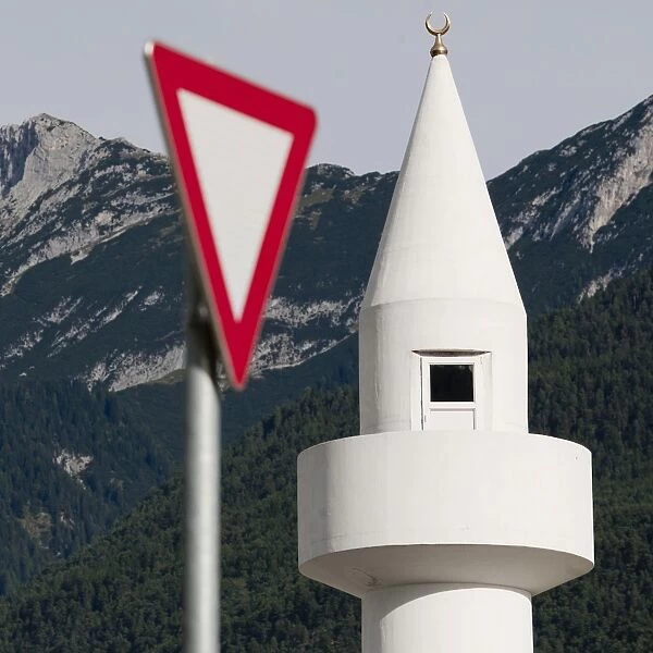 Yield-sign with minaret, controversial mosque in Telfs, Tyrol, Austria, Europe