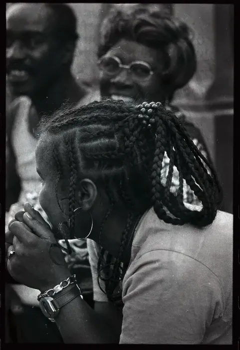 Framed Print : Young Black Woman Leaning over While in Conversation Framed Print : Young Black Woman Leaning over While in Conversation