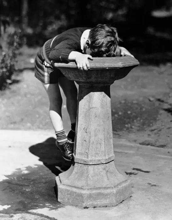 Framed Print : Young boy drinking from water fountain Framed Print : Young boy drinking from water fountain