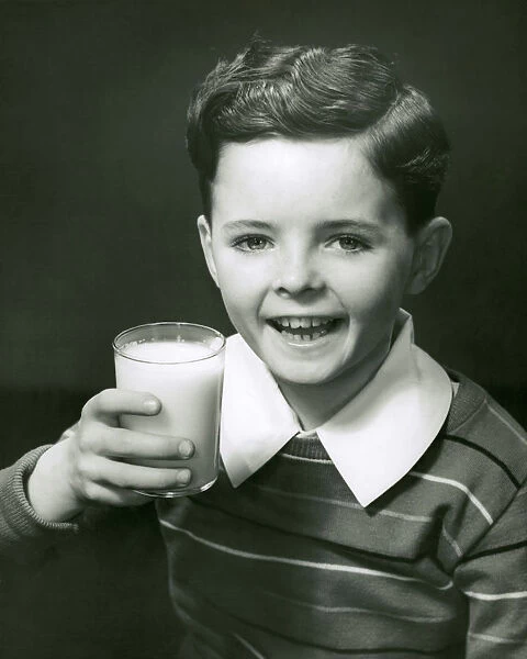 Young boy with glass of milk