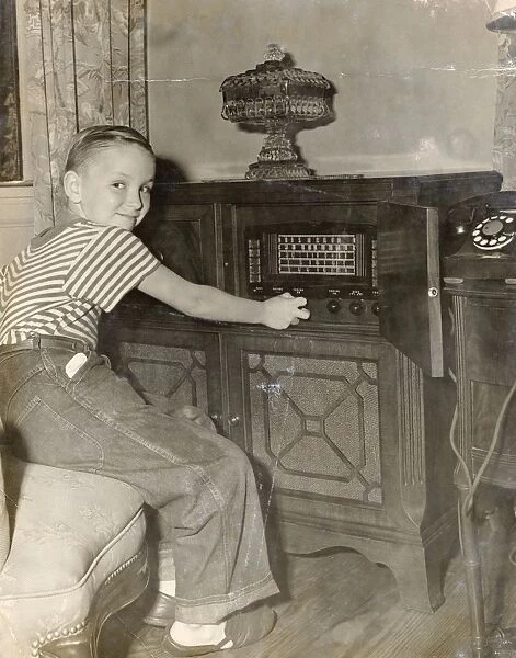 Young Boy Operating a Radio in His Living Room