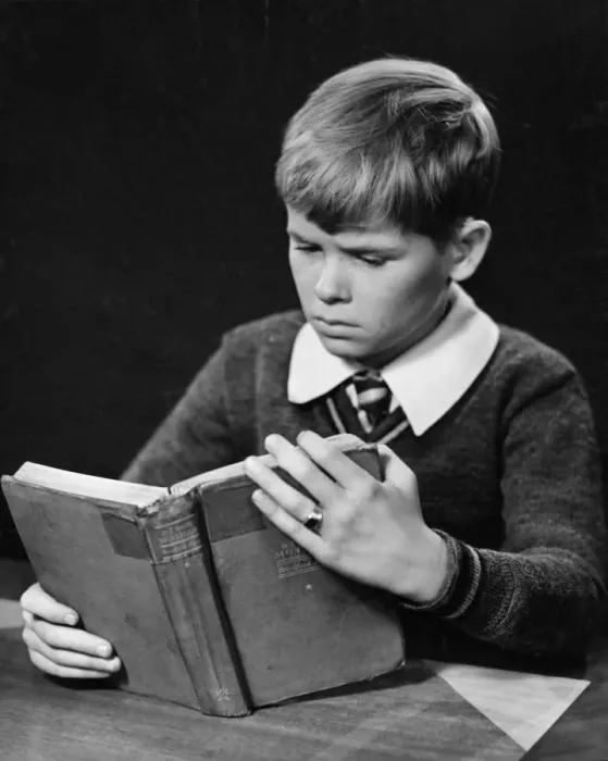 Framed Print : Young boy reading book Framed Print : Young boy reading book