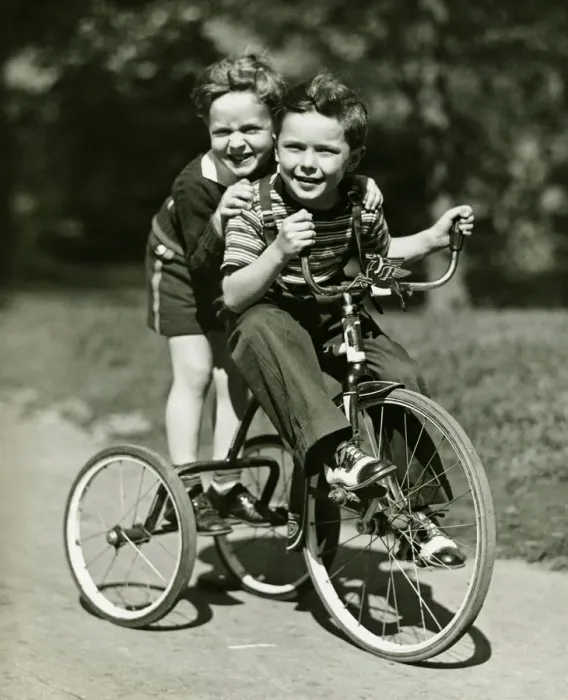Framed Print : Two young boys (6-7) riding tricycle in park, (B&W), portrait Framed Print : Two young boys (6-7) riding tricycle in park, (B&W), portrait