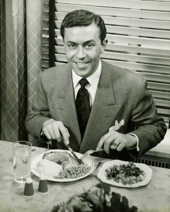 Framed Print : Young businessman eating dinner, (B&W), portrait Framed Print : Young businessman eating dinner, (B&W), portrait