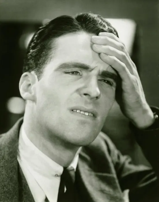 Framed Print : Young businessman with headache, (B&W), close-up Framed Print : Young businessman with headache, (B&W), close-up