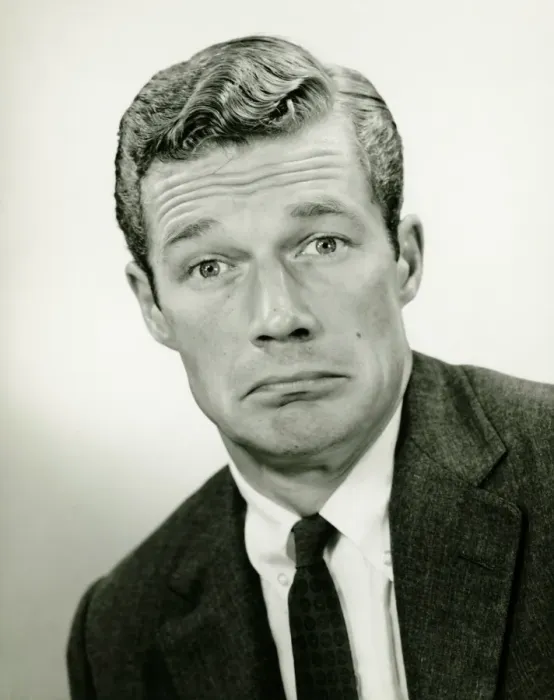 Framed Print : Young businessman looking sad, posing in studio, (B&W), portrait