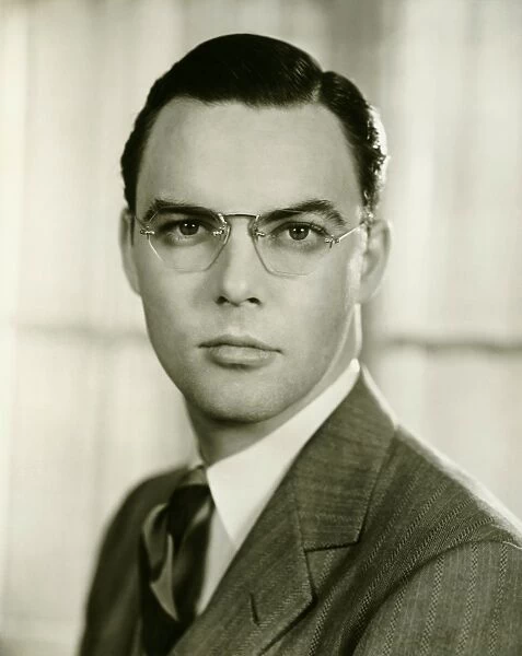 Young businessman in spectacles, (B&W), portrait