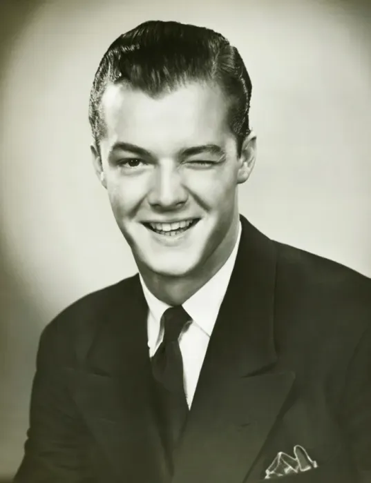 Framed Print : Young businessman winking, posing in studio, (B&W), portrait Framed Print : Young businessman winking, posing in studio, (B&W), portrait