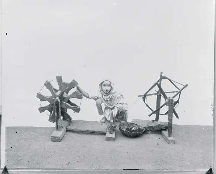 Framed Print : Young Child Using Charka to Weave Framed Print : Young Child Using Charka to Weave