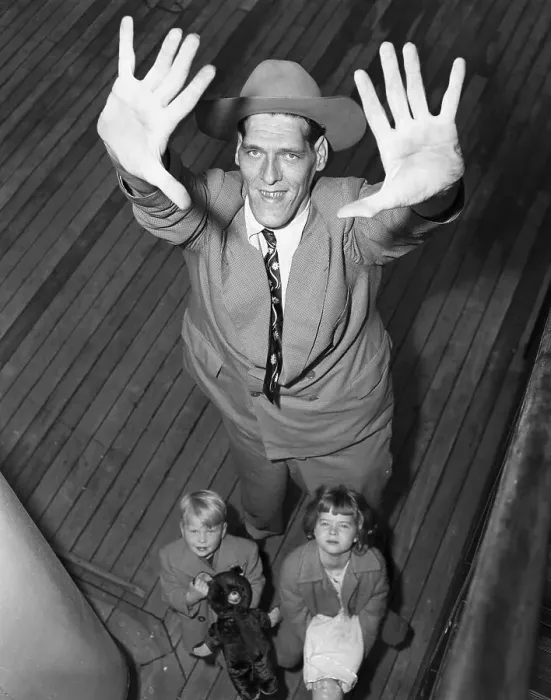 Framed Print : Young Children Standing Under Giant Man Framed Print : Young Children Standing Under Giant Man
