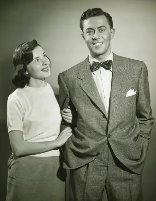Framed Print : Young couple arm in arm in studio, woman looking at man, smiling, (B&W) Framed Print : Young couple arm in arm in studio, woman looking at man, smiling, (B&W)
