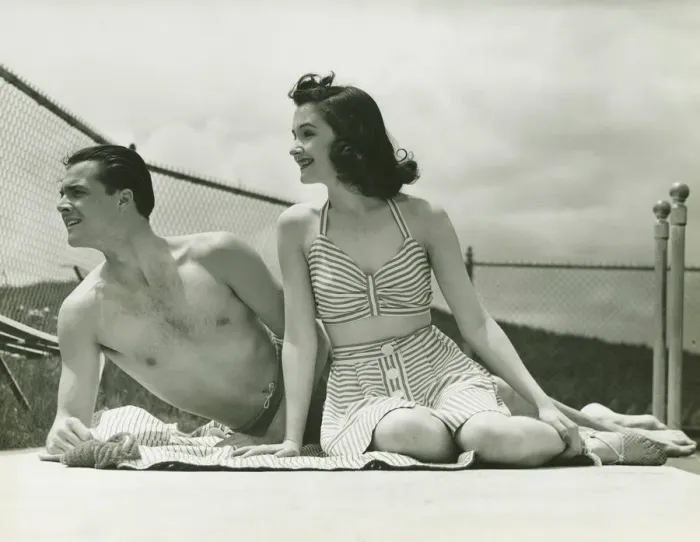Framed Print : Young couple in beachwear relaxing outdoors, (B&W) Framed Print : Young couple in beachwear relaxing outdoors, (B&W)