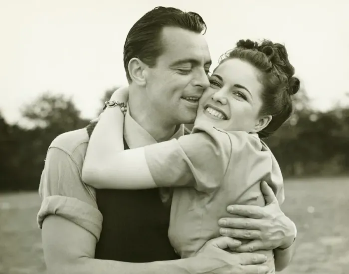 Framed Print : Young couple embracing in field, man kissing woman, (B&W)